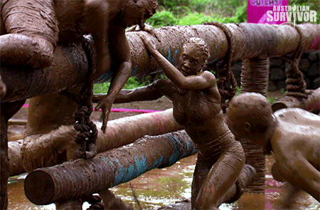 gif of a bunch of people struggling and falling in the mud, covered in it