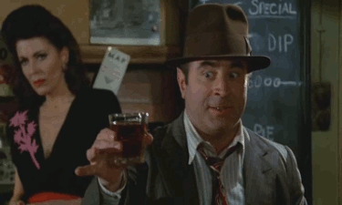 Bob Hoskins in the scene from Who Framed Roger Rabbit where he tries to hand him a drink. He's holding the drink out and nodding.