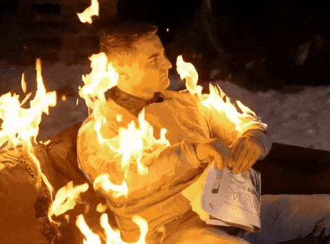 Man on fire holding newspaper chill like nothing is happening