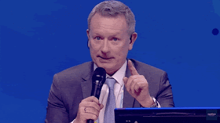 Jon Ola Sand taps his microphone and says 'take it away'. (There's no sound.)