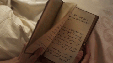 GIF of a hand opening a diary