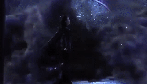 GIF of a figure enveloped in dark smoke