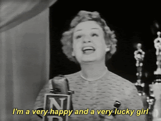 A black and white gif of an Oscar winner from years ago. (I don't know who the actress is.) She's making an acceptance speech and the caption says, 'I'm a very happy and a very lucky girl.'