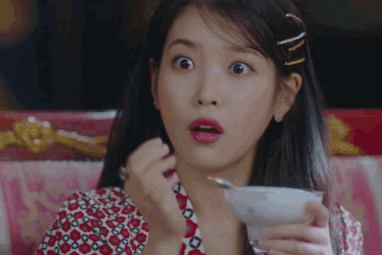 shocked young Korean woman with hand over mouth