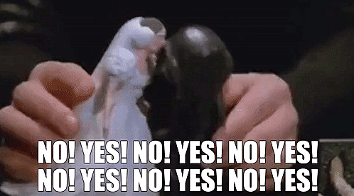 GIF from 'Spaceballs' showing Dark Helmet playing with dolls, having them dramatically say 'no!' and 'yes!' while pretending they are kissing.