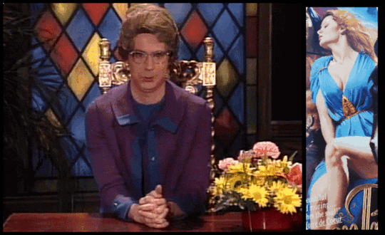 gif of The Church Lady from SNL raising her eyebrow, then looking to the side at a close-up view of the cover of Demon Prince. The cover shows a woman in a flowy blue dress, her head turned in ecstasy. With her hand and lap blocked by her leg, it appears as if she's pleasuring herself.