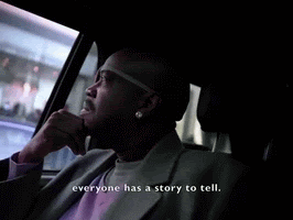 A black man in the back of a car is thoughtfully looking out of the window, as he travels through a town. The caption says, 'Everyone has a story to tell.'