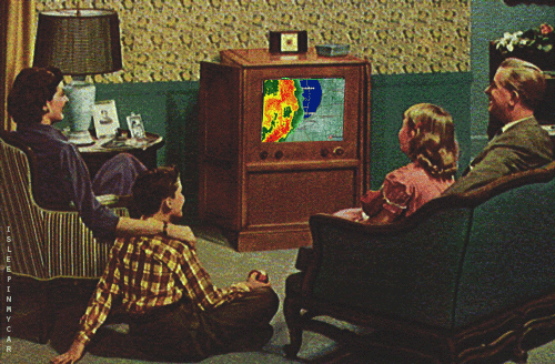 nuclear family watching TV