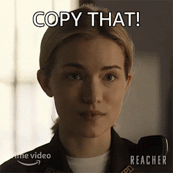 A blonde white woman in local sheriff uniform is saying, 'Copy that.'