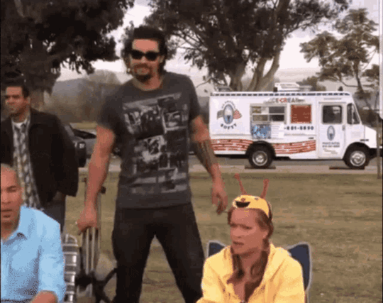man putting down a chair and then sitting in it