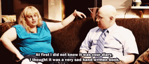 a man and a woman are sitting on a couch and the woman says 