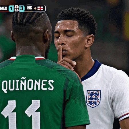 Jude Bellingham, wearing an England shirt is shushing the Mexican player, Quinines, on the pitch.