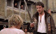 From A Knight's Tale. The King is touching his sword on the shoulders of Heath Ledger's character, in the middle of the jousting ring.