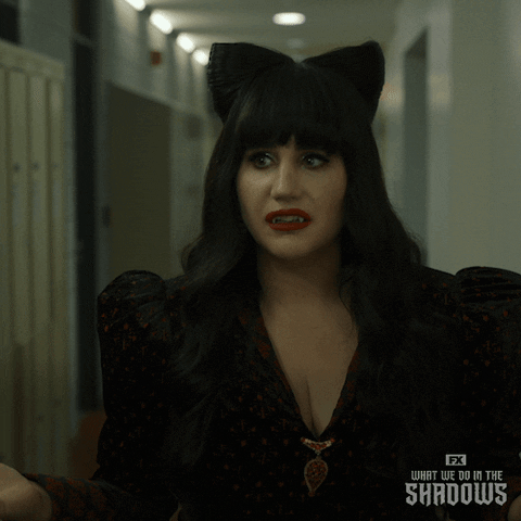 Nadja from What We Do in the Shadows smiles eagerly with her vampire fangs showing, and says: 'Hell yes! I'm all in.'