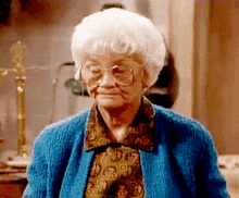 old woman shakes head dismissively