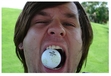 The bass player of Relient K with a golf ball in his mouth. Found it on flickr. Very accurately captures his personality.
