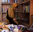 A woman looking through books in Afghanistan