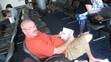 Mr. Padgett reading in the airport waiting on the flight to China.